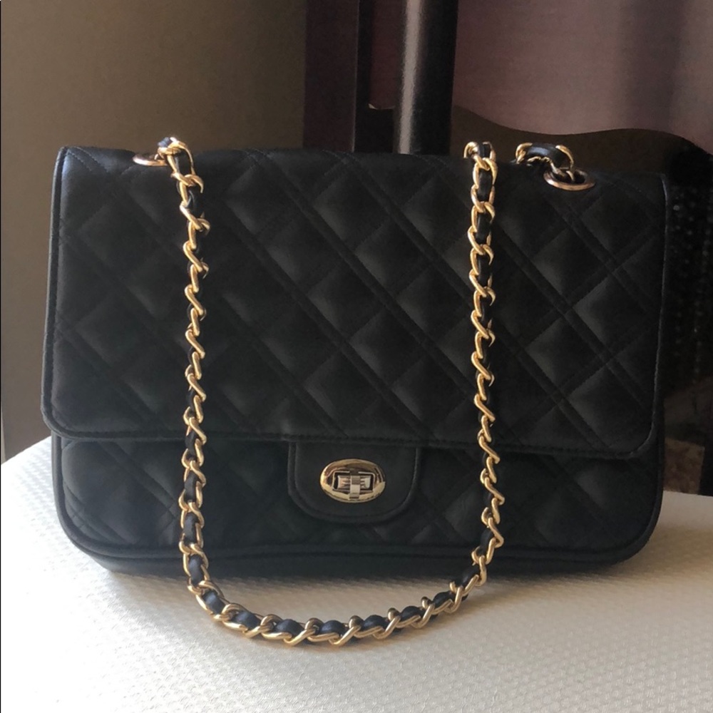 Black with a gold chain beautiful bag